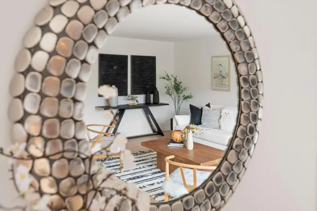 a living room with a couch and a chandelier