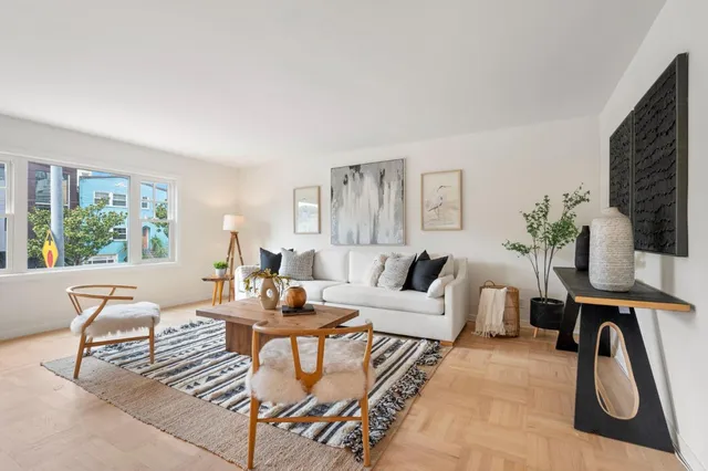 a living room with furniture a window and a flat screen tv