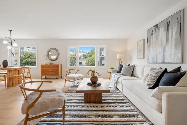 a living room with furniture a fireplace and a window