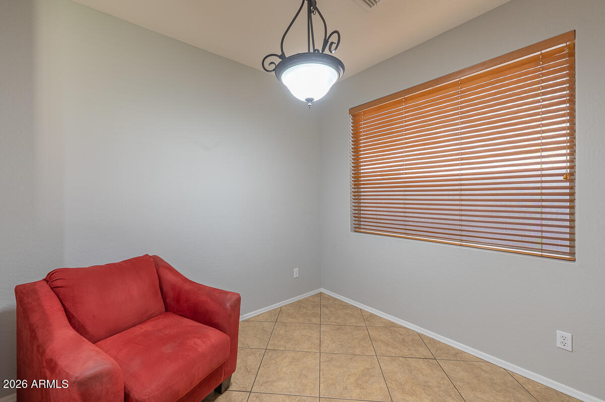 3328 East Merlot Street Gilbert, AZ 85298 - Photo 15 of 48 a blue room with window and a chandelier