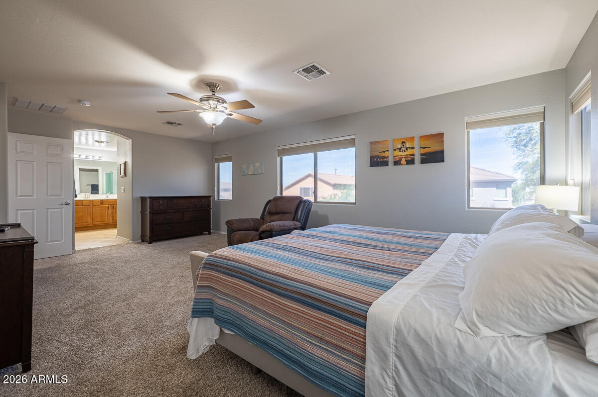 3328 East Merlot Street Gilbert, AZ 85298 - Photo 24 of 48 a bedroom with bed and window