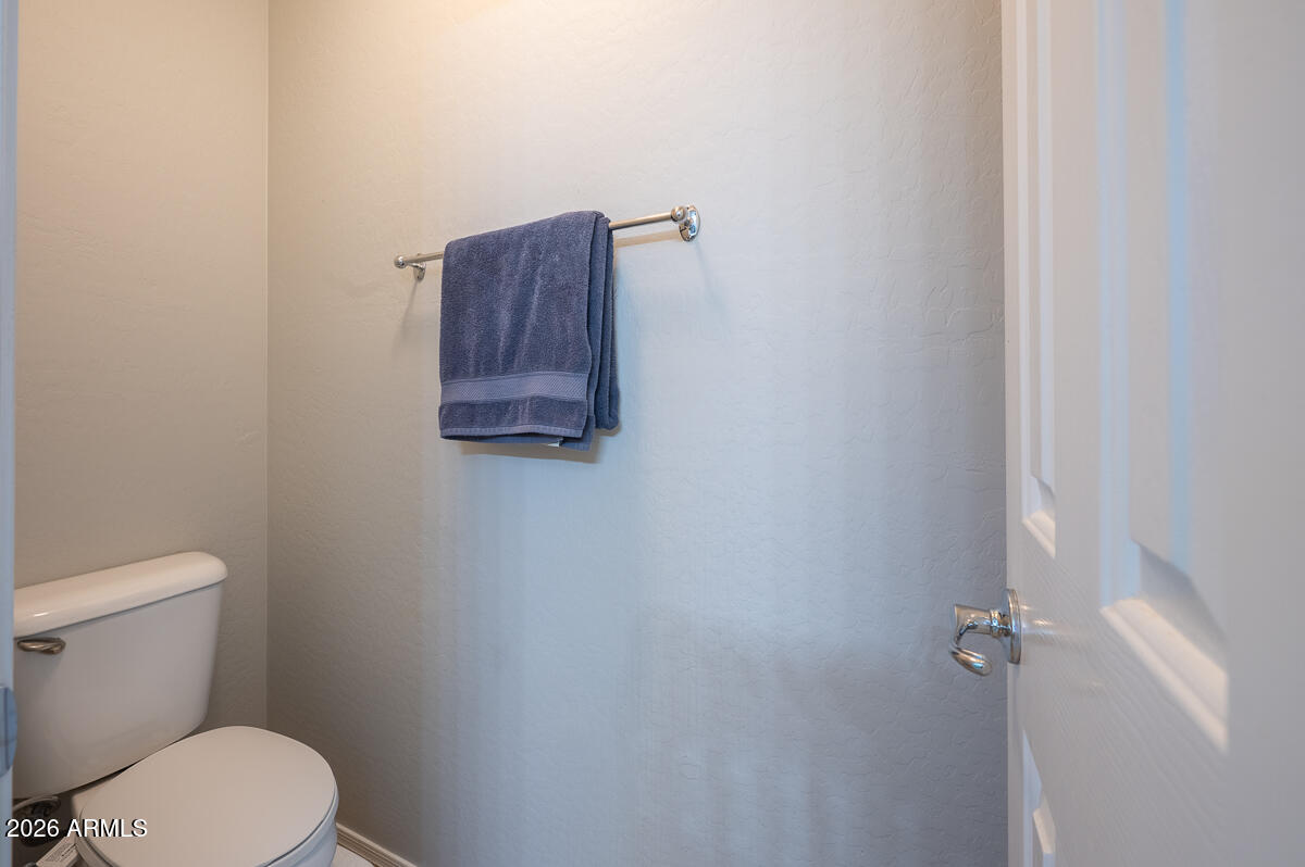 3328 East Merlot Street Gilbert, AZ 85298 - Photo 29 of 48 a white toilet sitting next to a shower