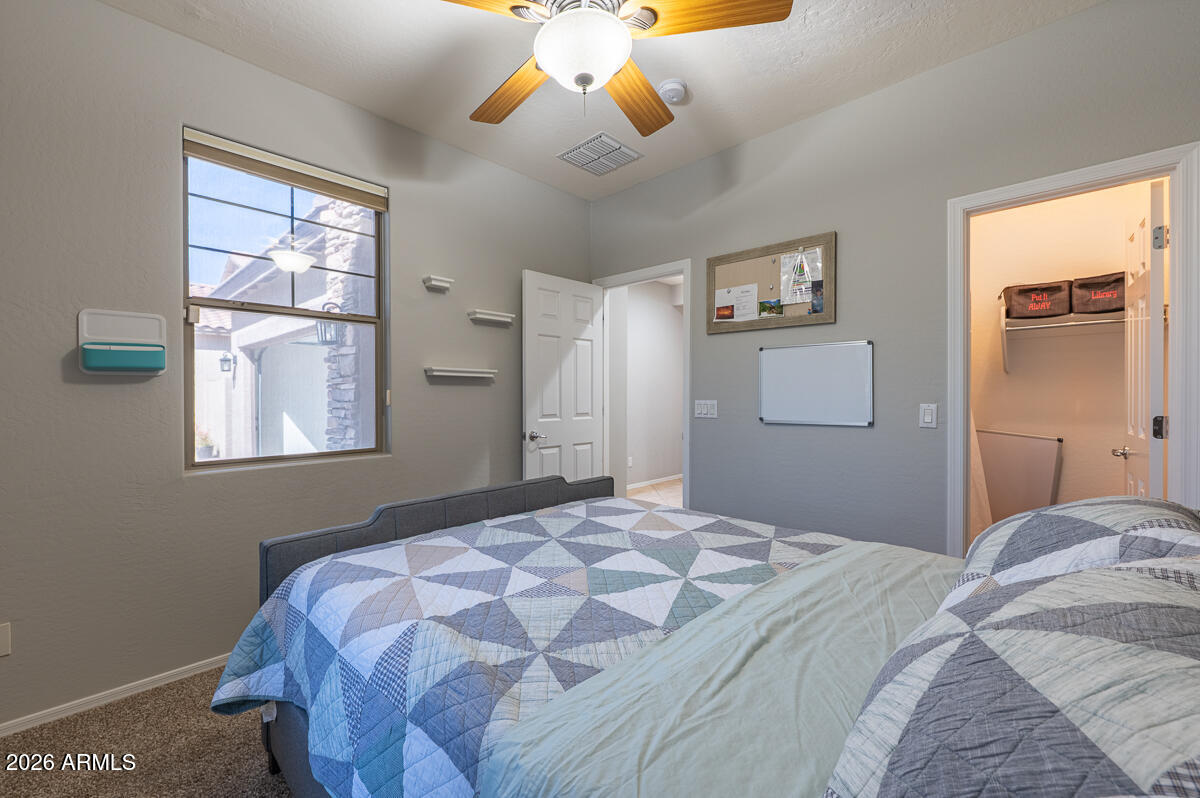 3328 East Merlot Street Gilbert, AZ 85298 - Photo 36 of 48 a bedroom with a large bed and a window
