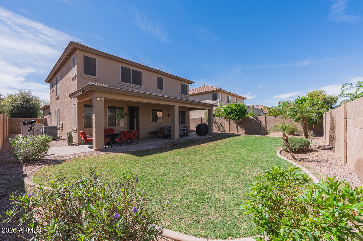 3328 East Merlot Street Gilbert, AZ 85298 - Photo 48 of 48 a front view of a house with a yard and potted plants