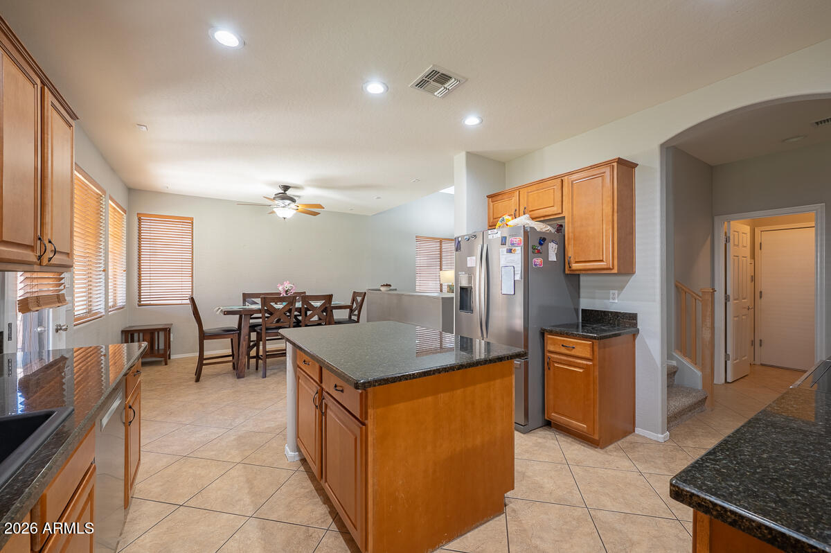 3328 East Merlot Street Gilbert, AZ 85298 - Photo 6 of 48 a kitchen with stainless steel appliances granite countertop a stove and a refrigerator