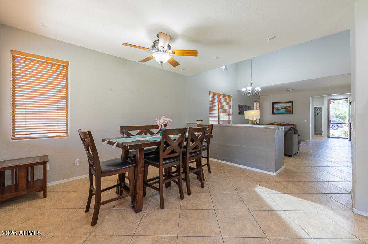 3328 East Merlot Street Gilbert, AZ 85298 - Photo 9 of 48 a view of a dining room with furniture and chandelier