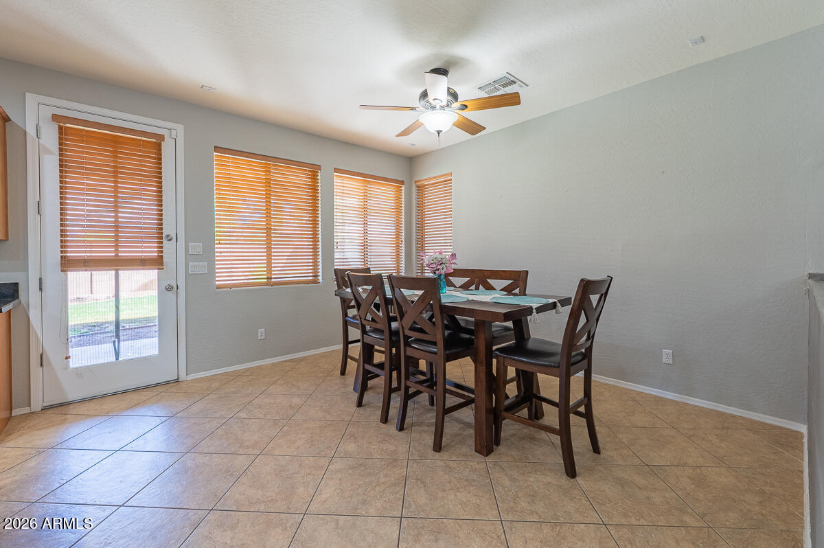 3328 East Merlot Street Gilbert, AZ 85298 - Photo 10 of 48 a view of a dining room with furniture and chandelier