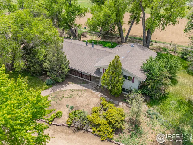 an aerial view of a house with a yard and garden