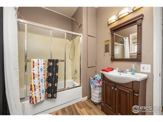 a bedroom with furniture and wooden floor