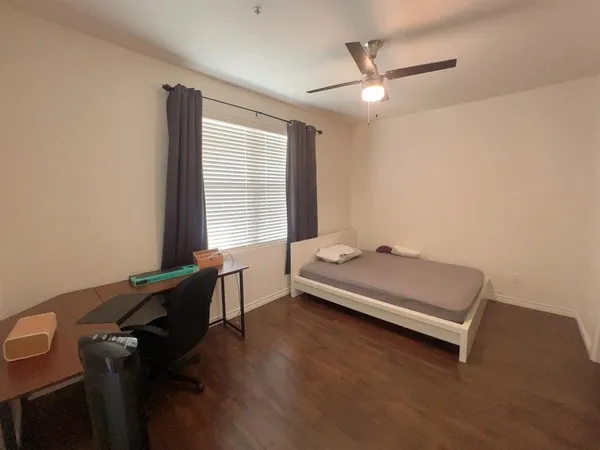 a room with a desk and a window