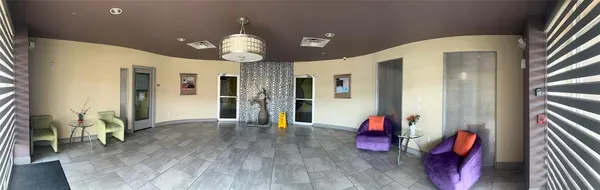 a view of an entryway with wooden floor and chandelier