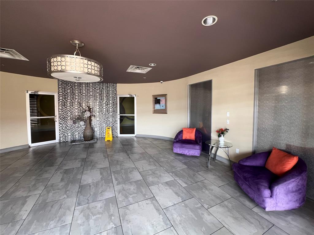 1100 West Trinity Mills Road, Unit 3015 Carrollton, TX 75006 - Photo 3 of 17 a living room with furniture and a fireplace