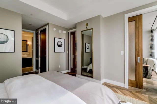 a bedroom with a bed and a mirror