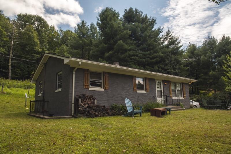 401 Sawmill Road Southwest Willis, VA 24380 - Photo 3 of 31 a backyard of a house with yard and outdoor seating