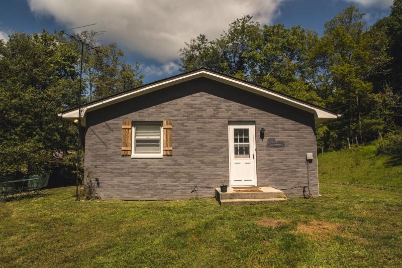 401 Sawmill Road Southwest Willis, VA 24380 - Photo 23 of 31 a front view of a house with a garden