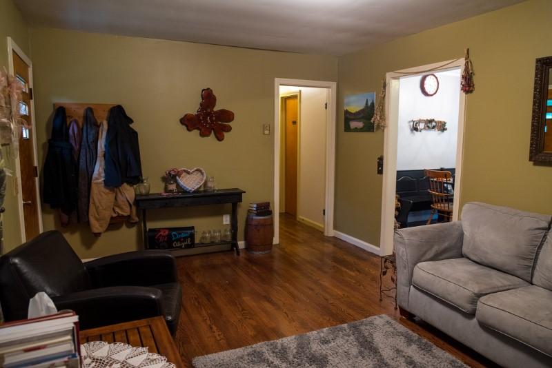 401 Sawmill Road Southwest Willis, VA 24380 - Photo 31 of 31 a living room with furniture and a wooden floor
