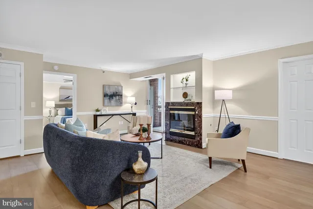 a living room with fireplace furniture and a table