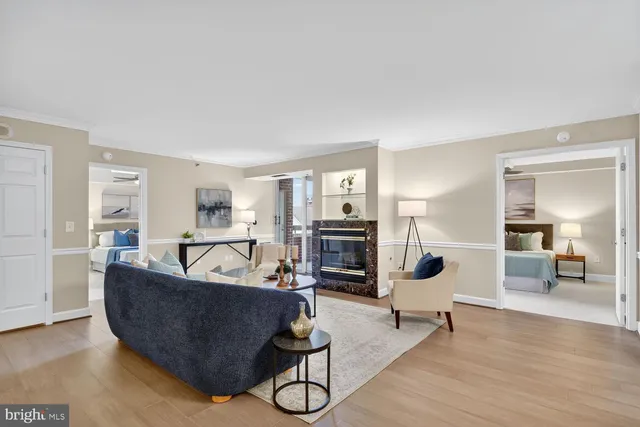 a living room with furniture and view of kitchen