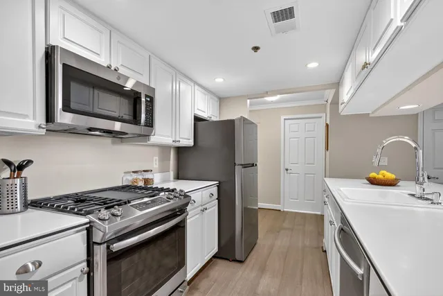 a view of living room with granite countertop lots of white furniture