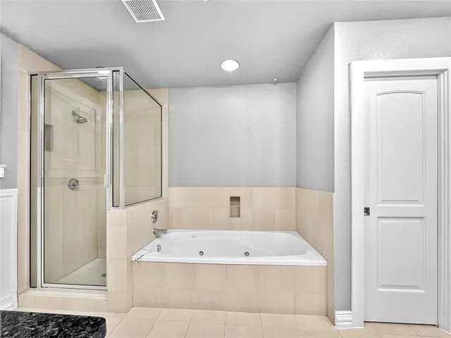 a bathroom with a tub shower and sink