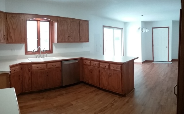 2208 Root Street Crest Hill, IL 60403 - Photo 6 of 21 a kitchen with stainless steel appliances granite countertop wooden floors and wooden cabinets