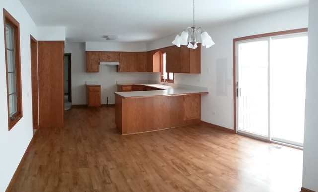 2208 Root Street Crest Hill, IL 60403 - Photo 8 of 21 a view of kitchen with granite countertop cabinets and refrigerator