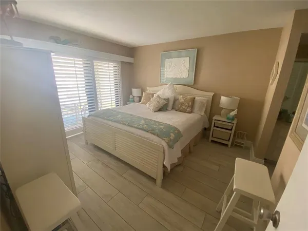 a bedroom with a bed and a chair