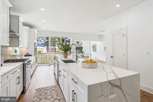 a kitchen with stainless steel appliances a lot of counter space and a sink