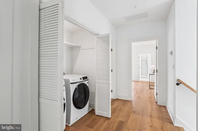a view of a hallway with washer and dryer