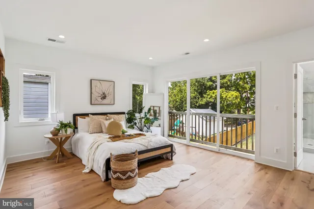 a bedroom with a bed and a large window
