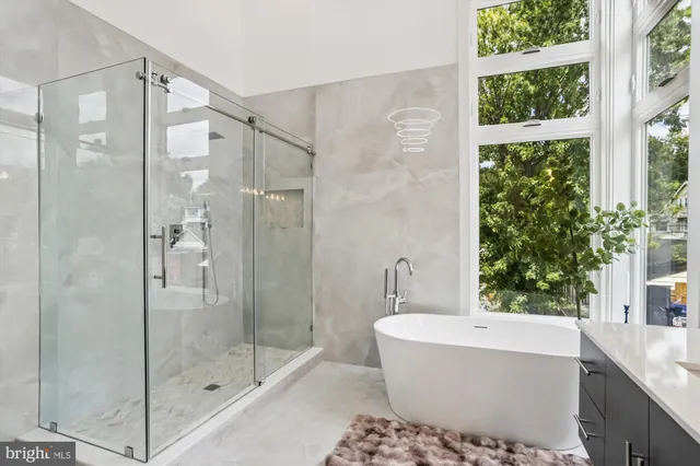 a bathroom with a bathtub and shower