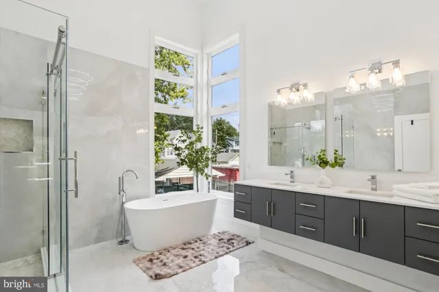 a spacious bathroom with a bathtub shower sink and mirror