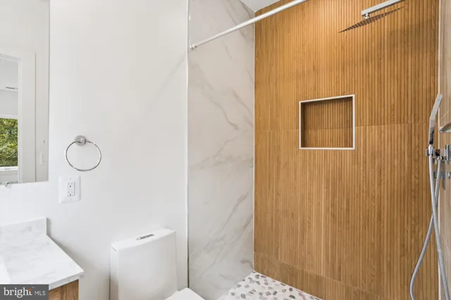 a bathroom with a shower and a sink