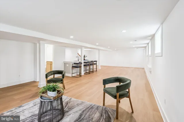 a living room with furniture a dining table and kitchen view