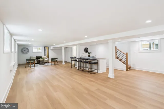 a living room with furniture and kitchen view