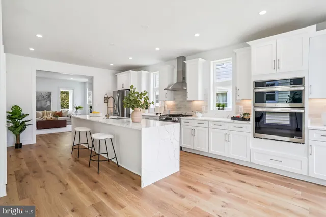 a kitchen with white cabinets and appliances