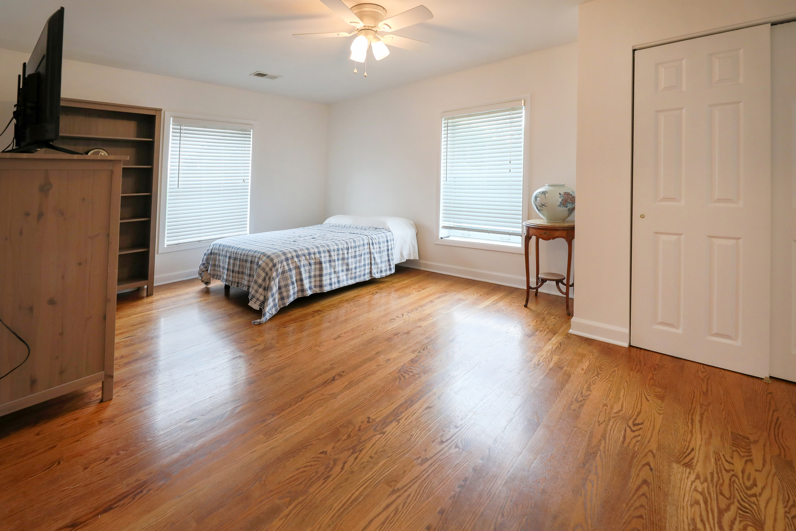 9601 Golf Road, Unit 304 Des Plaines, IL 60016 - Photo 14 of 20 a bedroom with a bed and wooden floor