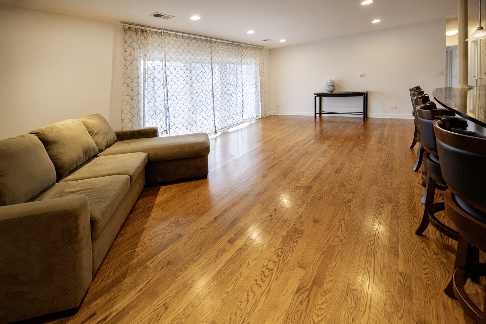 9601 Golf Road, Unit 304 Des Plaines, IL 60016 - Photo 3 of 20 a living room with furniture and a wooden floor