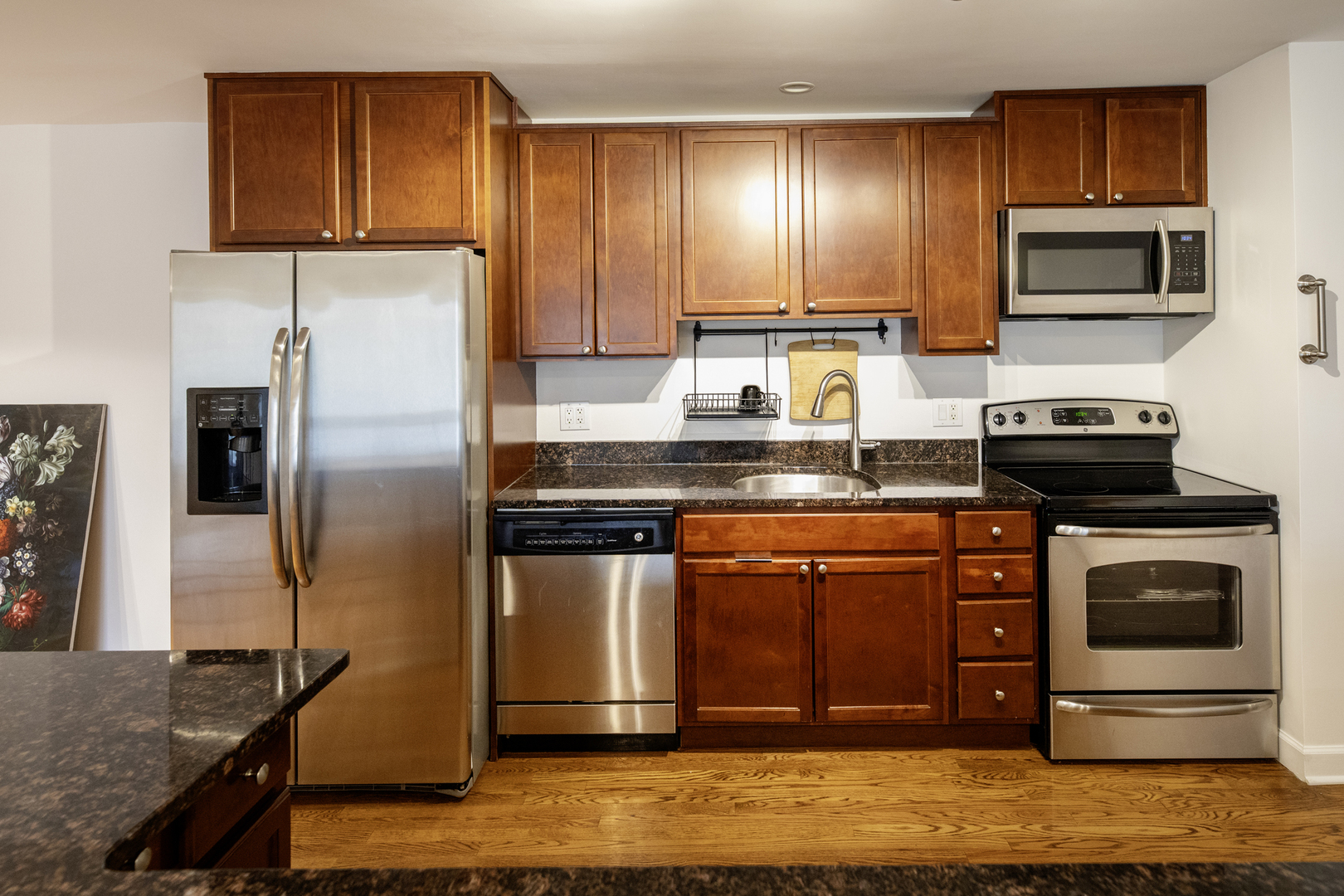 9601 Golf Road, Unit 304 Des Plaines, IL 60016 - Photo 8 of 20 a kitchen with stainless steel appliances granite countertop a stove a refrigerator and a microwave