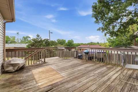 a view of balcony with deck and trees in the background