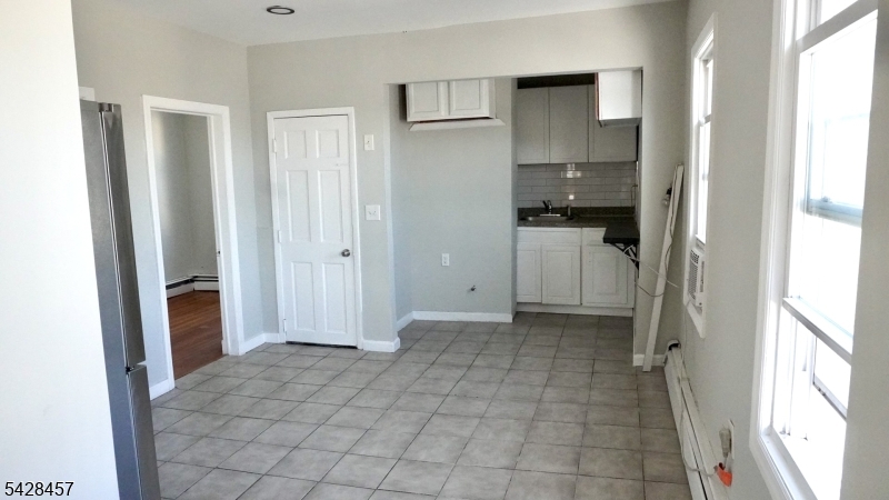 1007 Julia Street Elizabeth, NJ 07201 - Photo 11 of 20 a view of kitchen with furniture and refrigerator