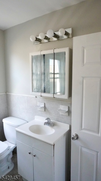 1007 Julia Street Elizabeth, NJ 07201 - Photo 13 of 20 a bathroom with a sink toilet and mirror