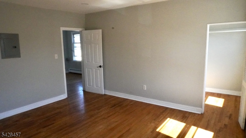 1007 Julia Street Elizabeth, NJ 07201 - Photo 14 of 20 a view of an empty room with wooden floor and a window