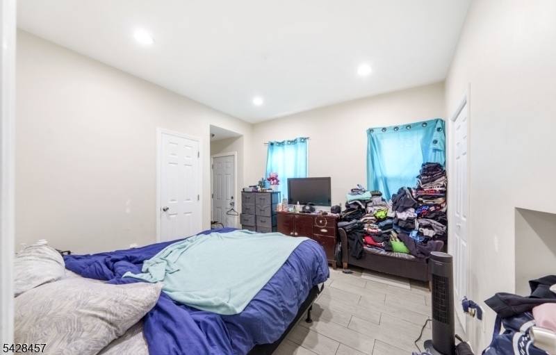 1007 Julia Street Elizabeth, NJ 07201 - Photo 7 of 20 a bed room with a bed window and a chair