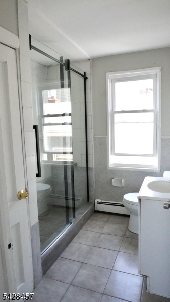 1007 Julia Street Elizabeth, NJ 07201 - Photo 10 of 20 a bathroom with a granite countertop sink toilet and shower