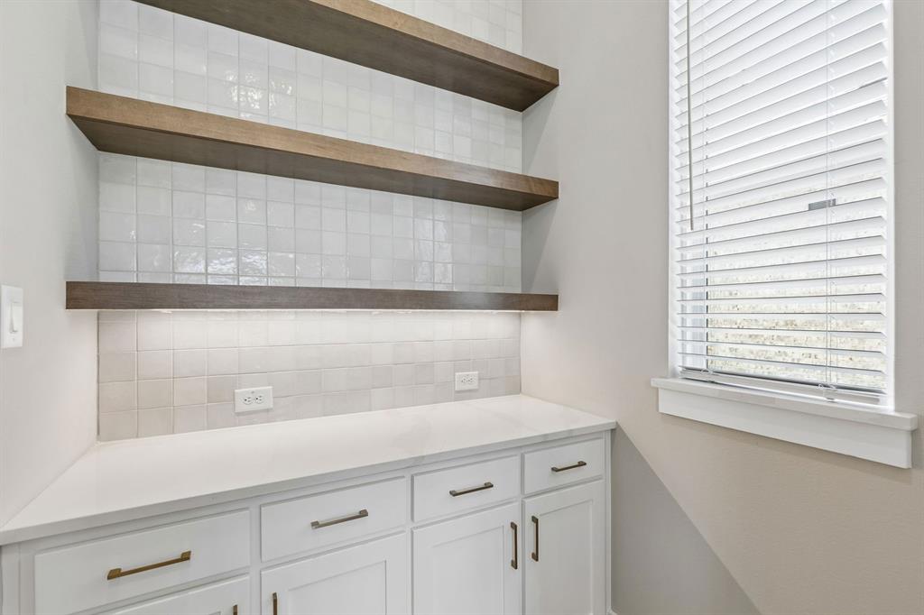 4512 Meander Way Prosper, TX 75078 - Photo 12 of 40 a view of white cabinets and a wooden floor