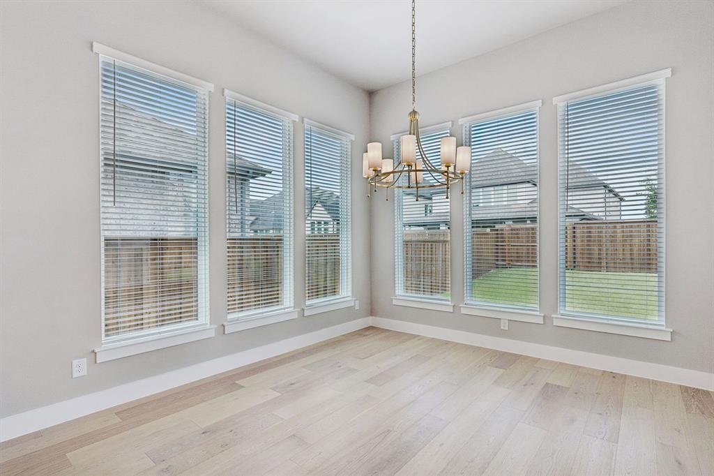 4512 Meander Way Prosper, TX 75078 - Photo 13 of 40 a view of livingroom with furniture wooden floor and windows