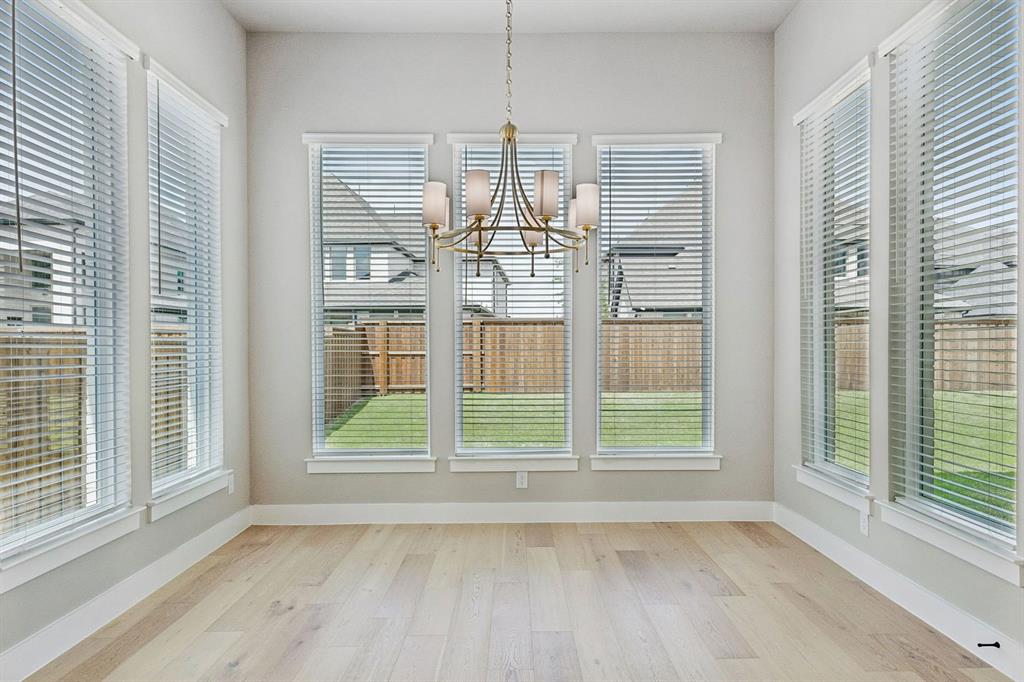 4512 Meander Way Prosper, TX 75078 - Photo 14 of 40 a view of a room with wooden floor and windows