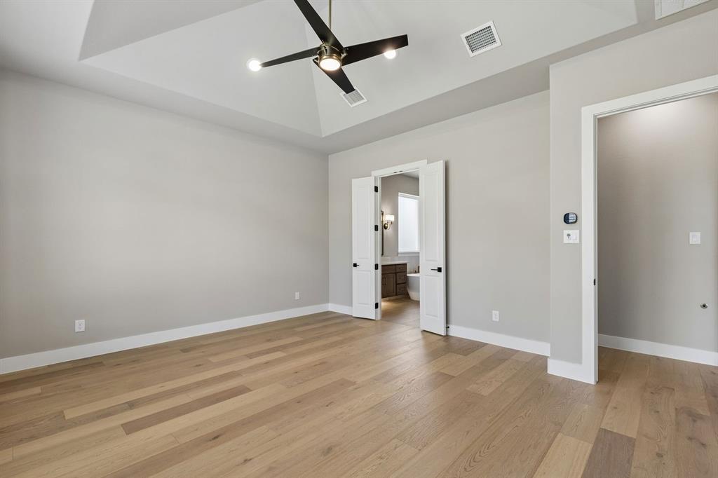 4512 Meander Way Prosper, TX 75078 - Photo 17 of 40 a view of empty room with wooden floor