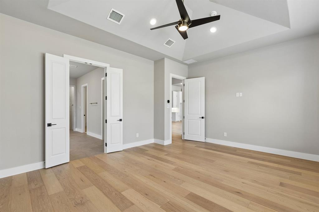 4512 Meander Way Prosper, TX 75078 - Photo 18 of 40 a view of a livingroom with a ceiling fan & entryway